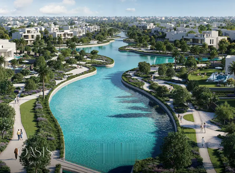 Aerial view of the lagoon waterway winding through the villas at The Oasis by Emaar