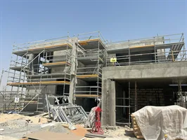 A two-storey villa at Mirage, The Oasis, in scaffolding with blockwork and render in progress