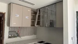 Kitchen units fitted and wrapped in protective plastic inside a Palmiera villa at The Oasis